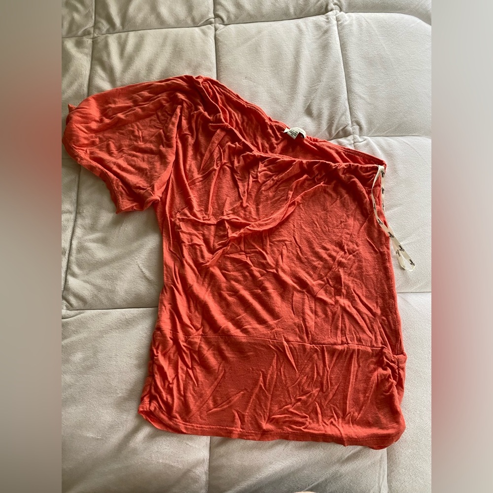 A one sleeved shirt that fits well and is lightweight and in perfect condition
